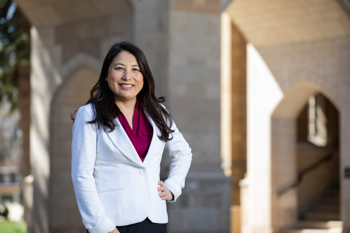 Dr. MayKao Hang poses outdoors on the St. Thomas campus.