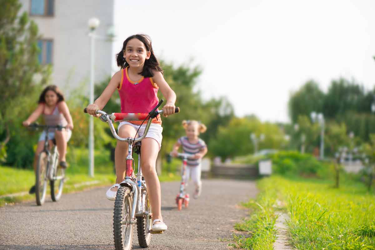 Young girl rides a bike
