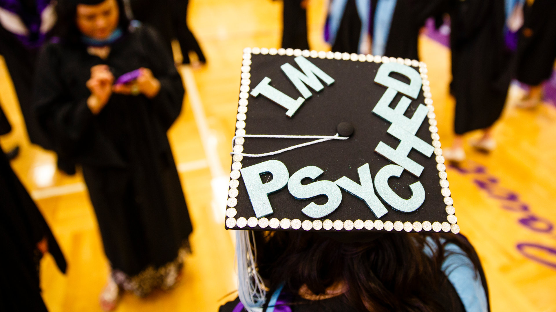 A graduation cap reading "I'm psyched"