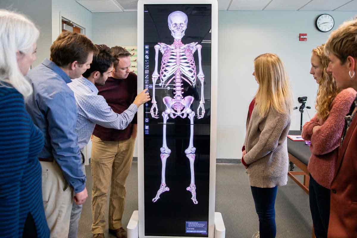 Students and faculty look at the Anatomage Table