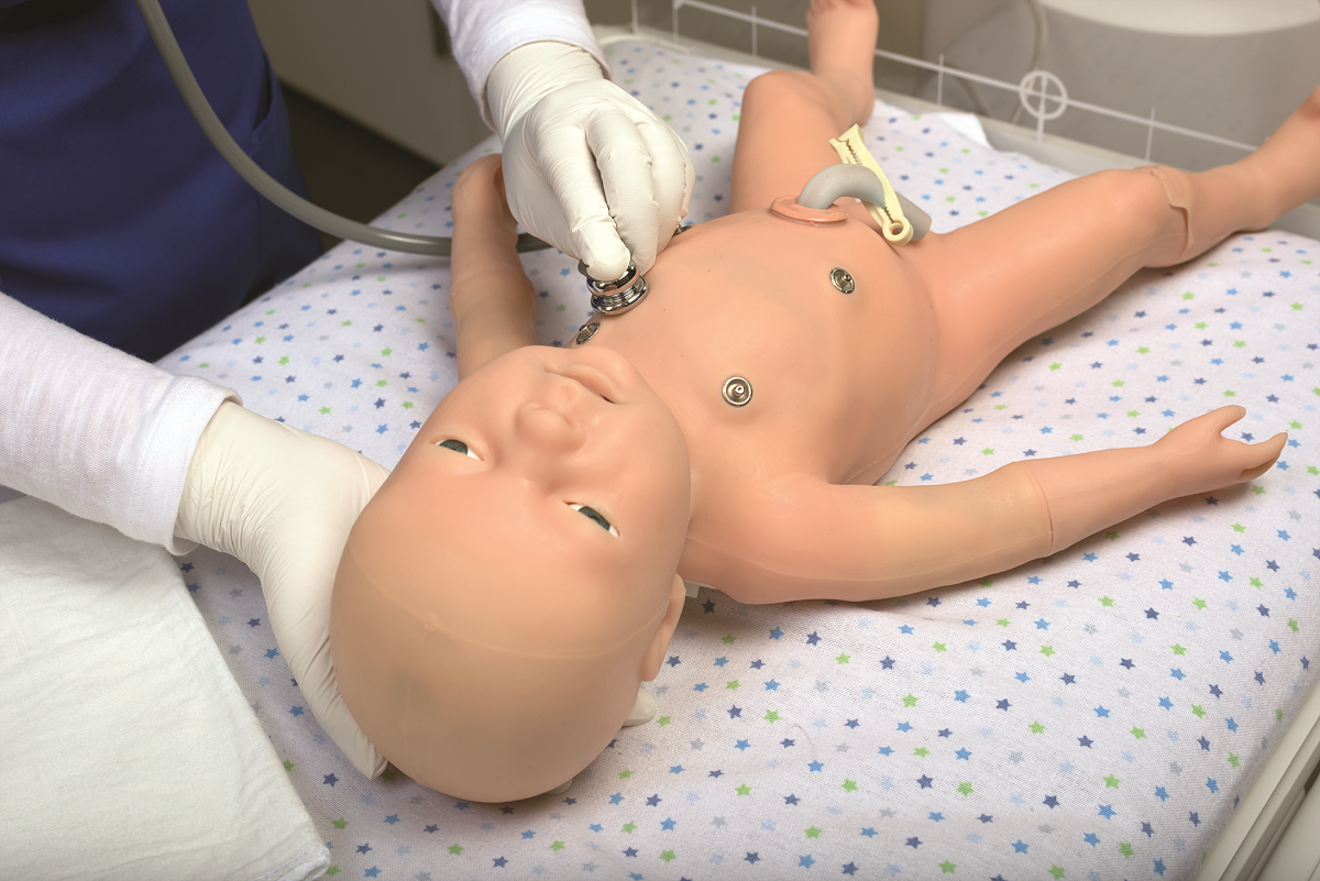 A nurse uses a stethoscope on a baby mannequin.