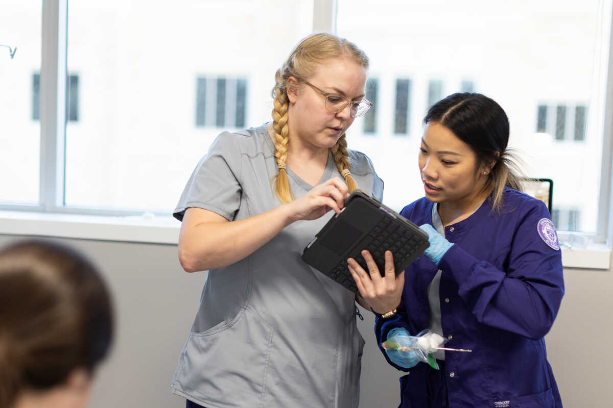 Two female nursing students using iPad