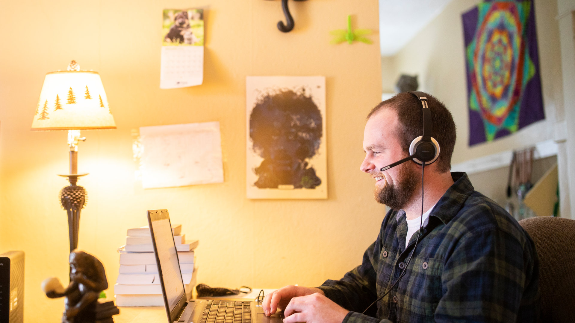 A grad student works from his home office space