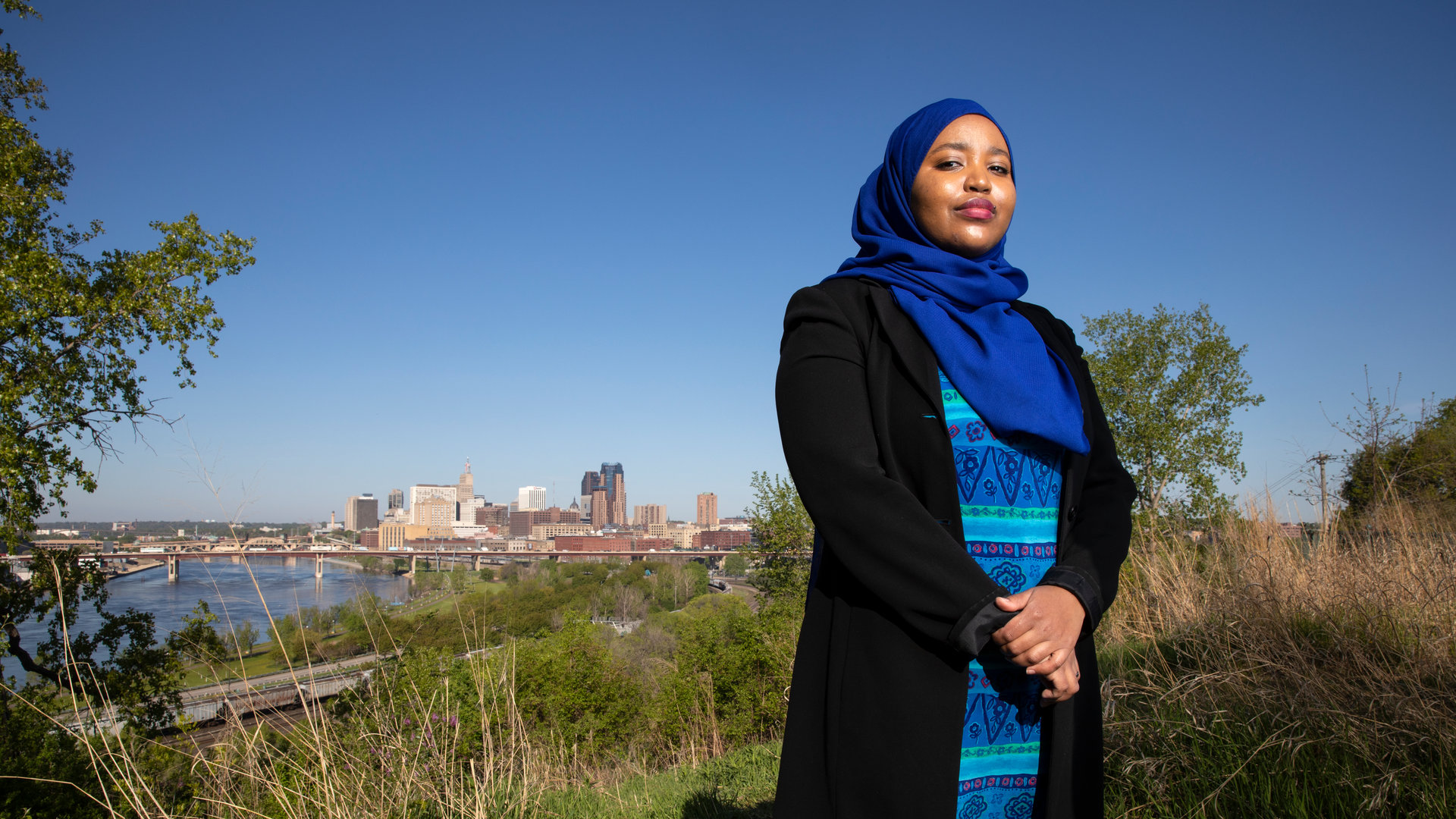 Ikram Koliso stands for a portrait at Indian Mounds Park overlooking downtown St. Paul