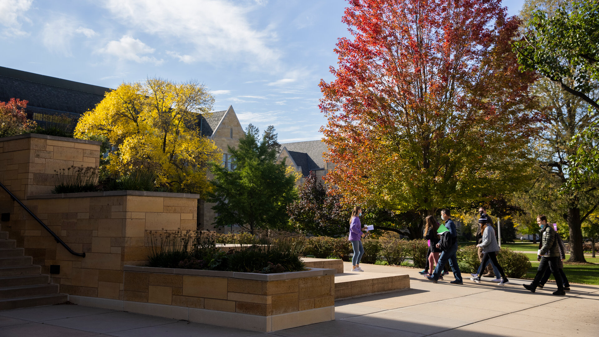 Students walk on campus in the fall