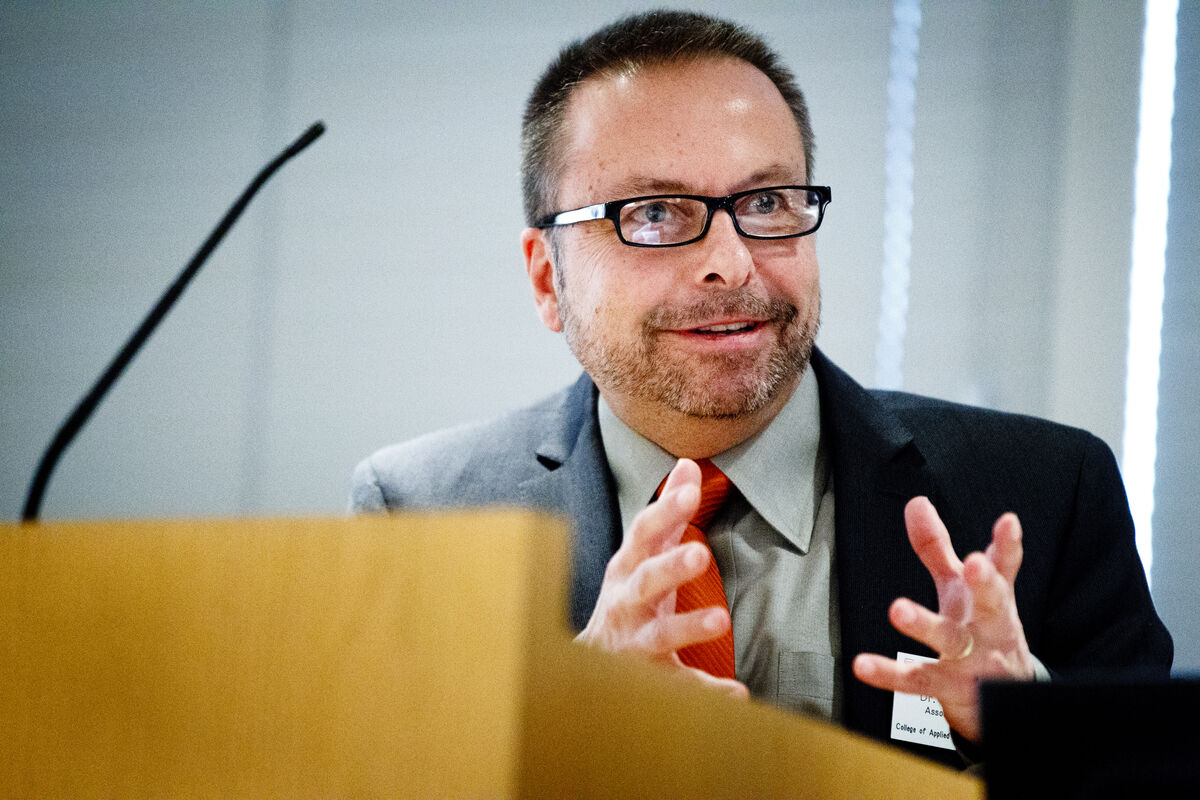 Doctor Christopher Vye speaking at a podium