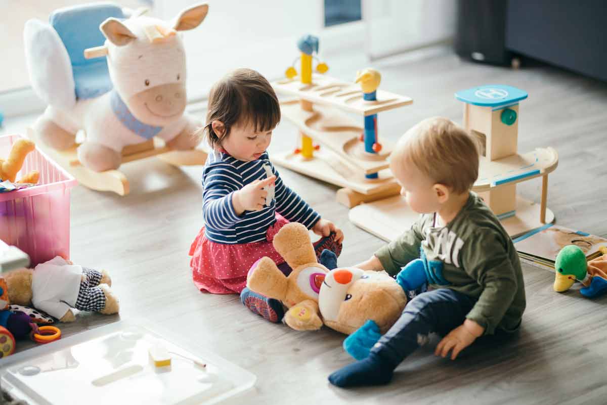 two young babies interacting