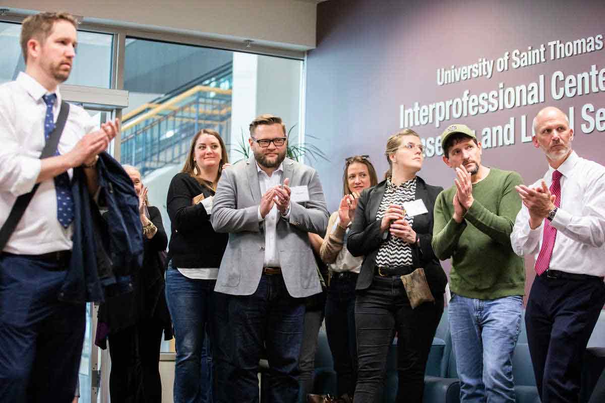 individuals clap at the inter professional center