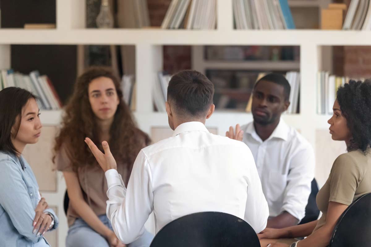 Group of people sit in a circle and talking