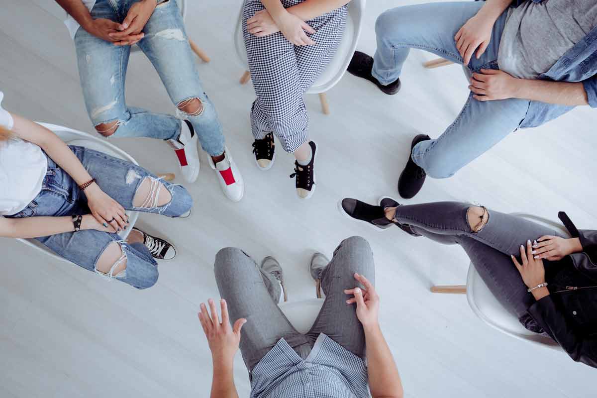Overhead view of people sitting in a circle for group therapy.