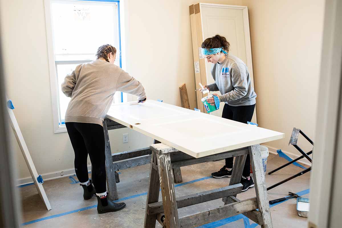 two individuals doing wood working