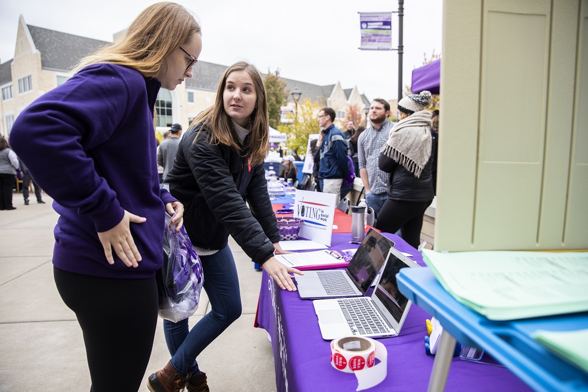 Social work student talks to another student about voting.