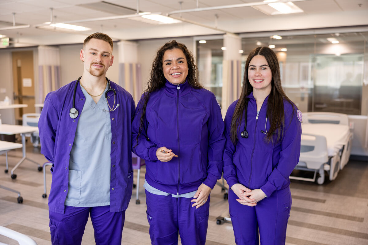 three people in nursing scrubs