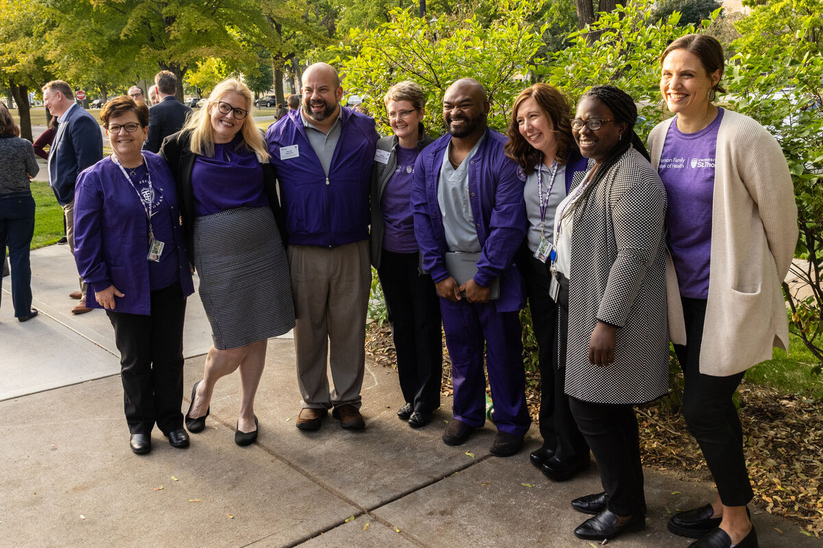 Faculty, staff, and students outside smiling
