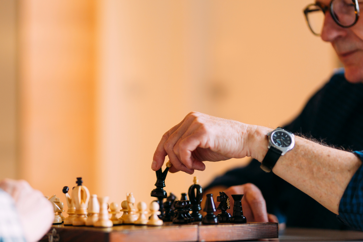 An older man plays chess