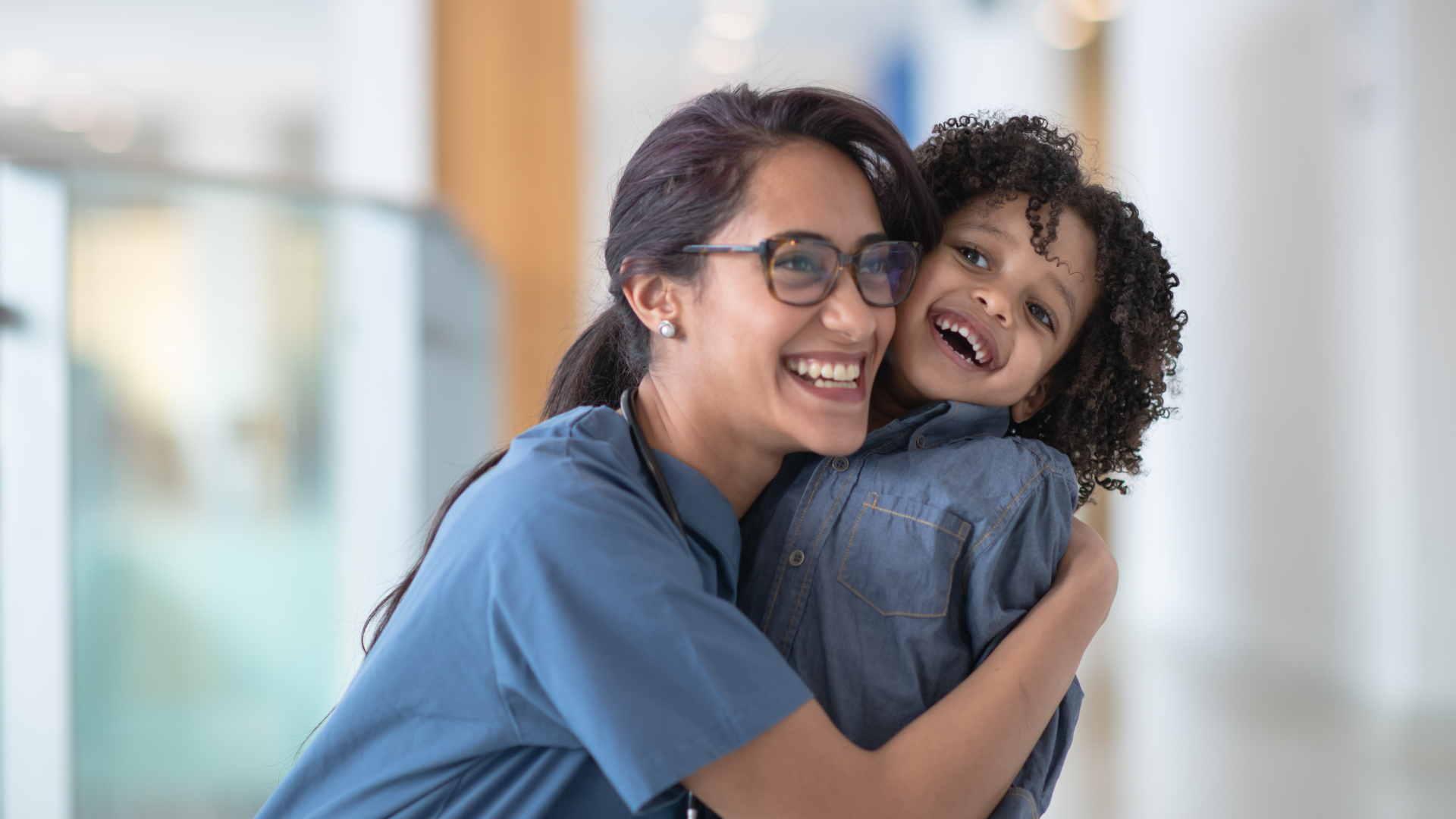 A mom and daughter laughing together