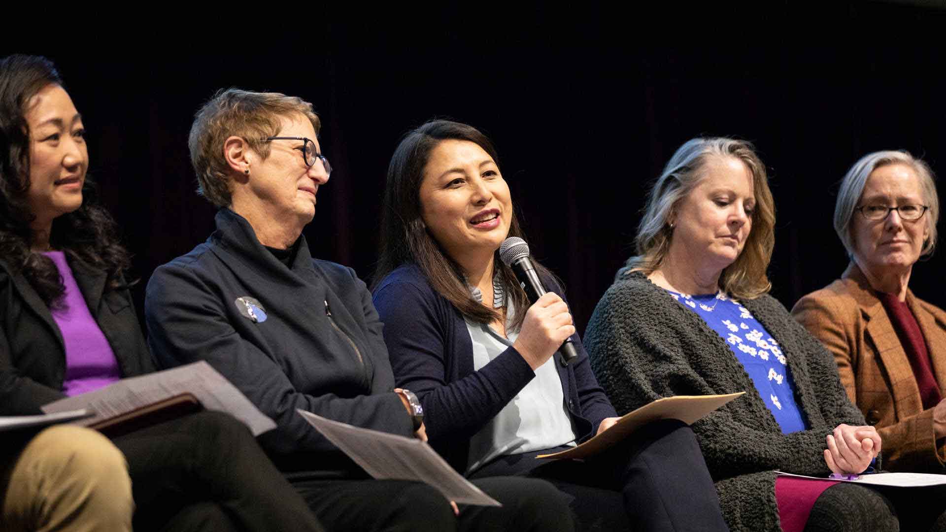 Dr. MayKao Hang speaking into a microphone