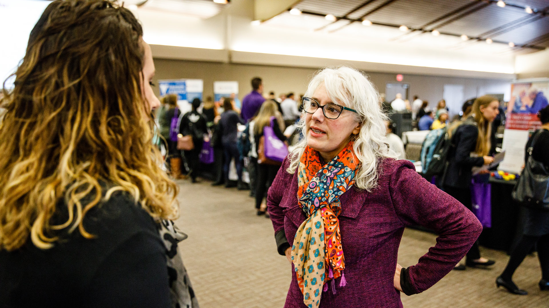 Faculty member talking to an alum.