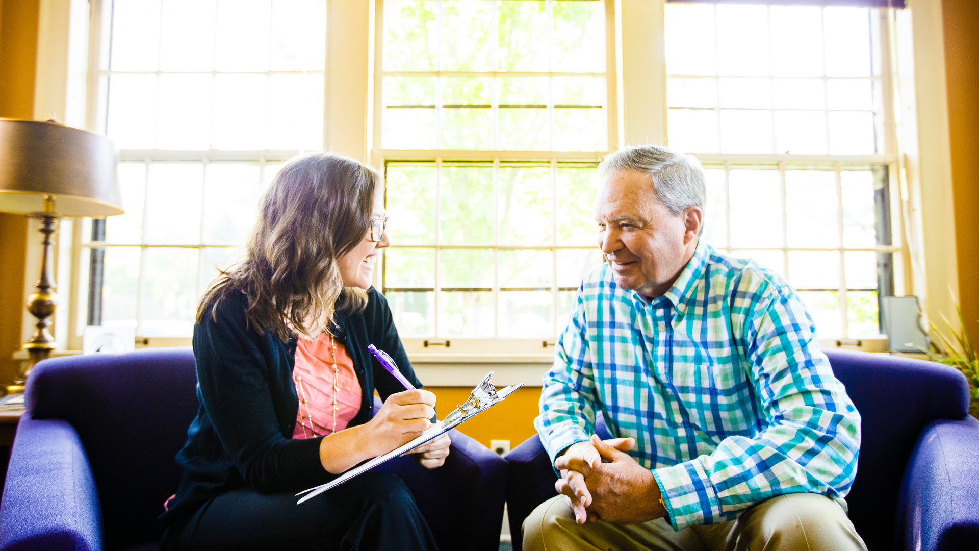 Social worker visits with an older adult