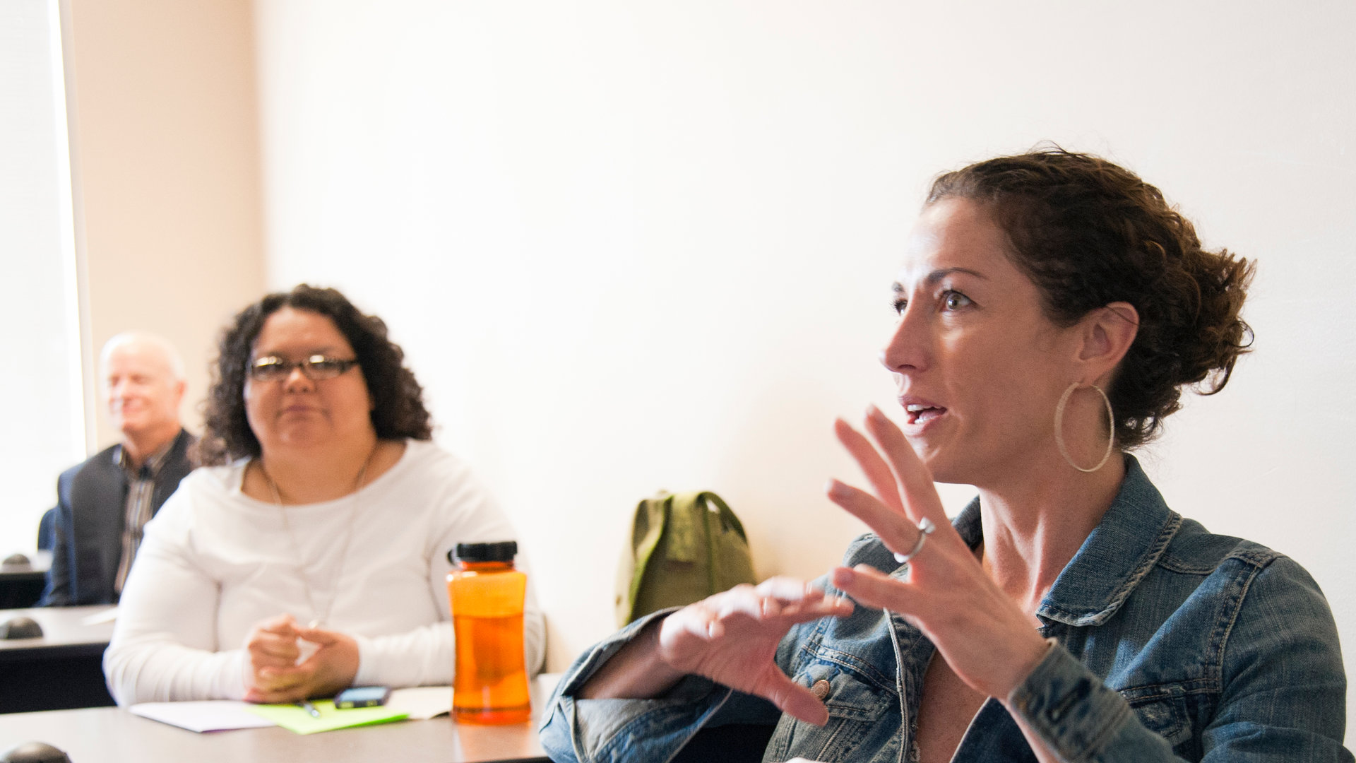 An MSW student asks a question during class