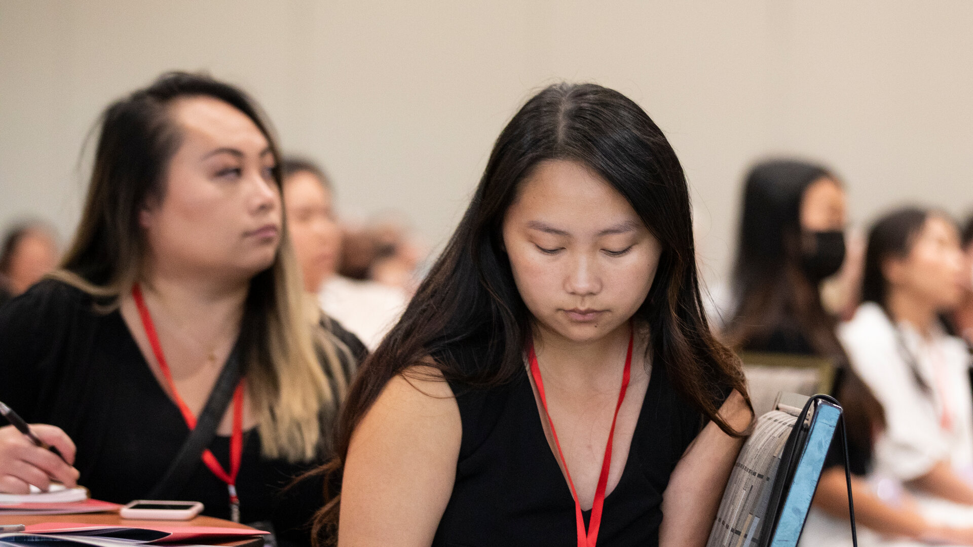 Students take notes at a conference
