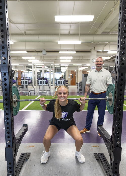 Student lifting weights