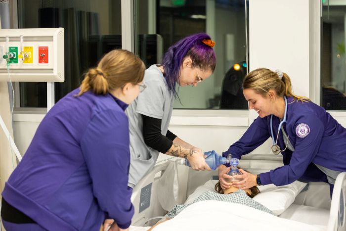 Students working on a nursing simulation