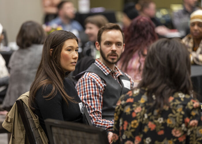 people sitting at a table talking to colleagues