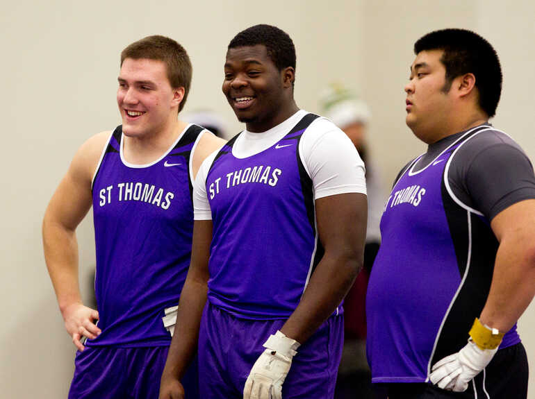 Three men take part in track and field