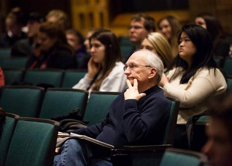 People sit in a lecture hall.